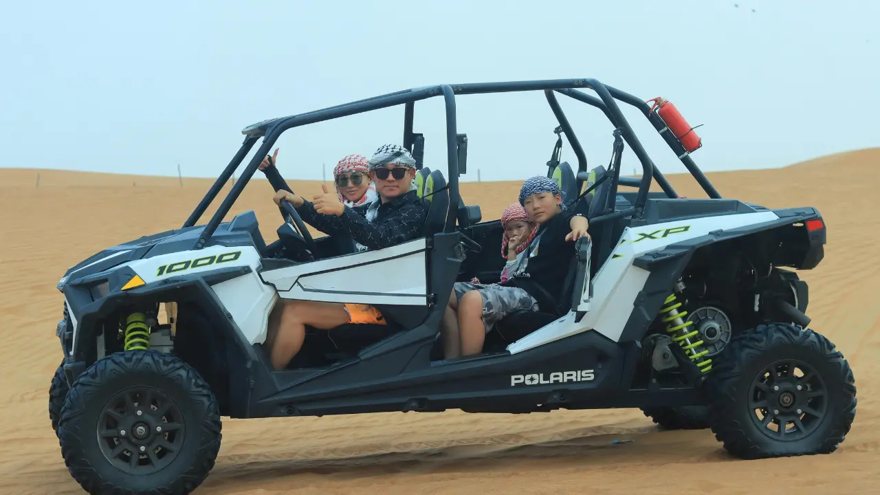 Desert Safari Tour Trip Guide – Best Dubai Safari Experience 22 Powerful dune buggy parked on Dubai desert sand with tour price signage in the background